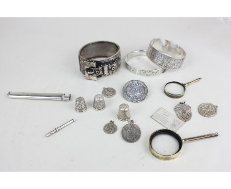 Two silver bangles, a white metal buckle bangle, three silver thimbles, a silver stamp, a Victorian Indian rupee in brooch mo