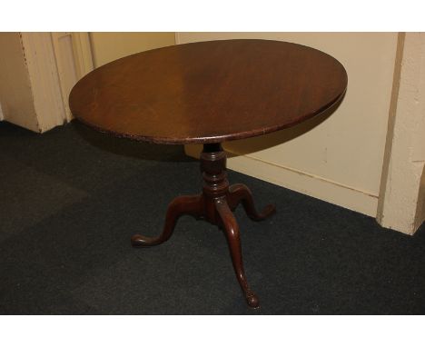 A George III mahogany circular tilt-top tea table on baluster stem and tripod base, 90cm