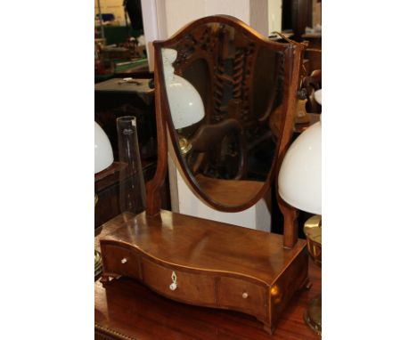 A mahogany shield shaped dressing table mirror on box base with serpentine front and three drawers, on ogee feet, 42.5cm