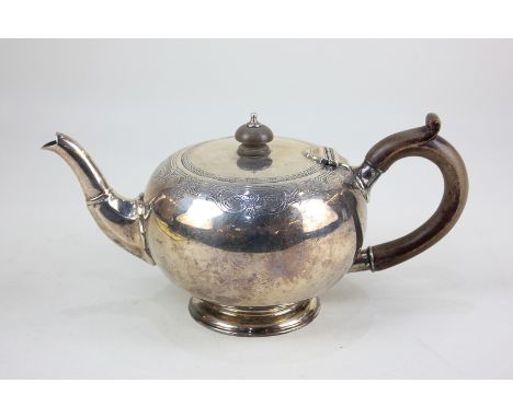 A George V silver teapot, circular shape with engraved border and wooden scroll handle, maker Garrard &amp; Co, London 1918, 