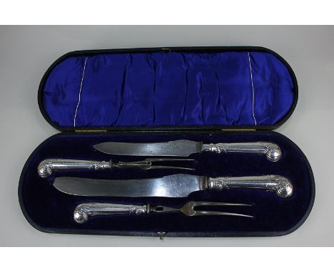 A George V silver handled carving set of two forks (one a/f), and two knives, in fitted case, maker Harrison Brothers &amp; H