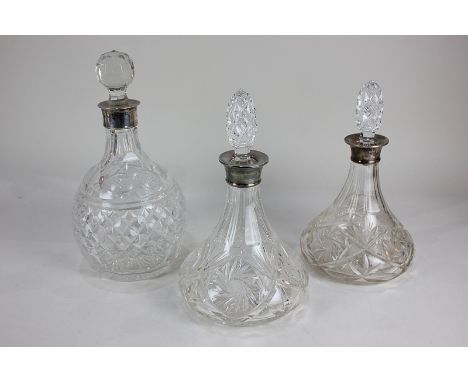 Two similar modern silver mounted cut glass decanters, flared form with associated stoppers, 29cm, and another cut glass glob