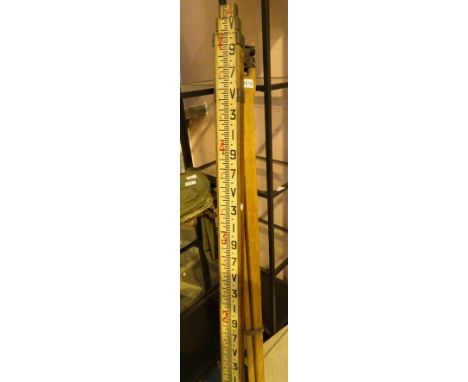 Vintage surveying tripod and a vertical measure