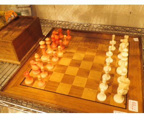 Complete ivory, white and stained red chess set and a wooden board, King H: 8 cm    CONDITION REPORT:  Postage & Packaging on