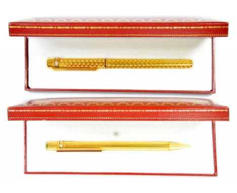 A LE MUST DE CARTIER GOLD PLATED FOUNTAIN PEN, THE GOLD NIB MARKED 750 18K AND A LE MUST DE CARTIER GOLD PLATED AND ENAMEL BA