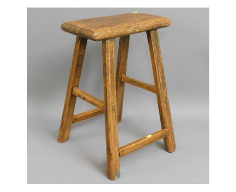 An early 19thC. elm rustic farm house stool, 21.5in high