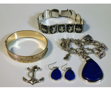 An Asian silver bracelet, a silver charm bracelet, a silver mounted lapis lazuli earring &amp; pendant set, a silver anchor p