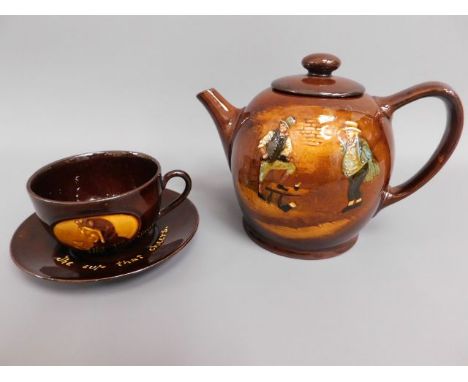 A Royal Doulton Kingswear teapot twinned with a similar tea cup &amp; saucer with motto "The Cup That Cheers" 