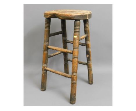 A 19thC. oak bum stool, 28.5in high, one stretcher missing