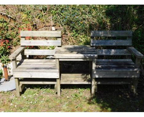 A robust two seater wooden bench with centre table, 73.25in wide