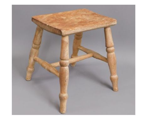A 19thC. elm stool with turned legs, 13.5in high