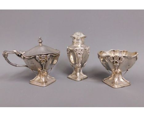 A Sheffield 1906 three piece silver arts &amp; crafts cruet set with applied decor by George Howson, tallest 3.5in, 202.5g