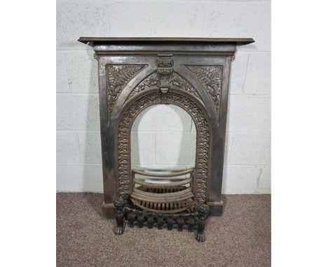 A Victorian style iron fire surround and grate, with arched niche and fern decoration, 102cm high, 78cm wide