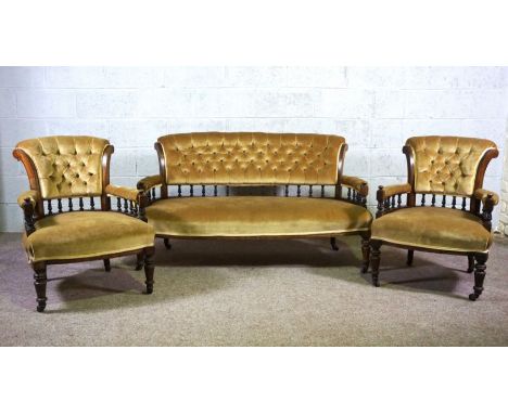 A late Victorian three piece parlour suite, comprising a settee and two bow arm chairs, circa 1900, currently upholstered in 