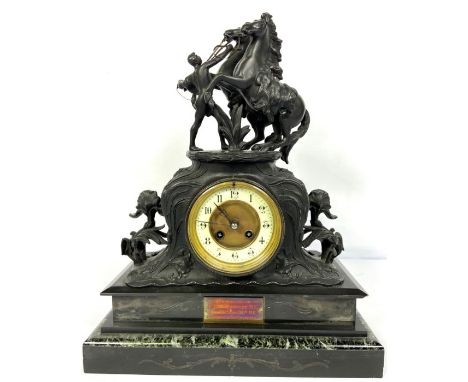 A Victorian spelter mantle clock, surmounted by two horses and their groom, 45 cm high