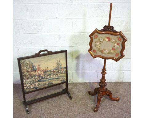 A Victorian turned pole screen, with decorative panel and tripod base, together with another firescreen (2)