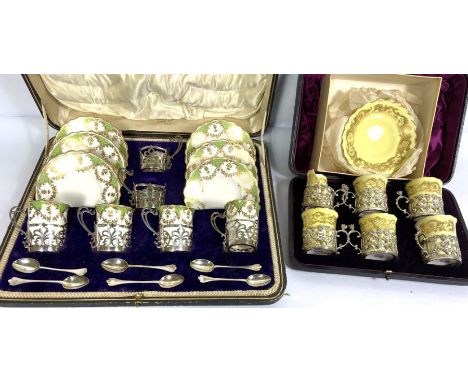A Royal Worcester six place coffee service, with silver holders, hallmarked London 1894, in a fitted case, with six matching 
