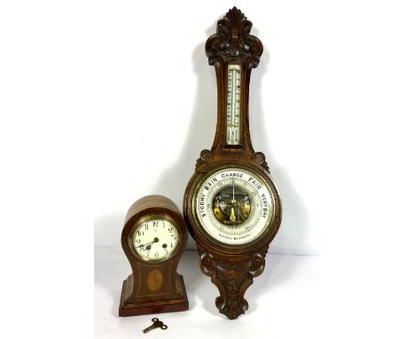 An Edwardian balloon top and inlaid mantel clock, 29cm high; And a Victorian oak cased aneroid barometer (2)