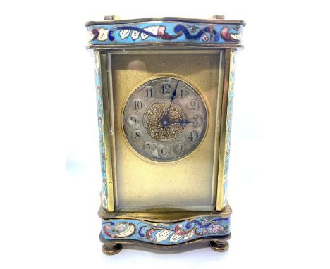 A French brass and enamel carriage timepiece, circa 1900, with circular silvered dial and Roman numerals, in a shaped decorat