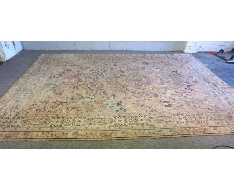 A Caucasian carpet, 20th century, with hunting figures and peacocks on a light pink ground, 280cm wide x 370cm long