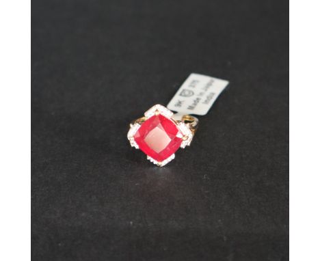 Gemporia - A Malagasy ruby and white zircon 9k gold ring, set with a 9.70ct cushion cut ruby and twenty-eight round white zir