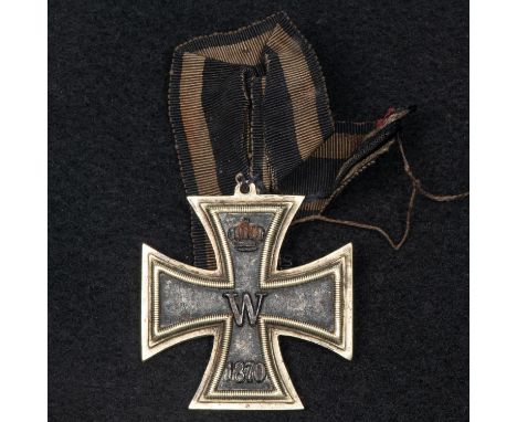 A Prussian 1870 Iron Cross, 2nd class, with integral horizontal loop and no ring suspender, sewn directly onto a length of ri