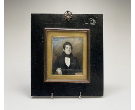 An early to mid 19th-century miniature portrait of a young gentleman seated by a table with books 8x7cm Condition: The image 