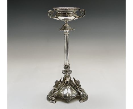 An Elkington silver table centre with a fluted column beneath a beaded bowl with three handles, the tripod base with three li