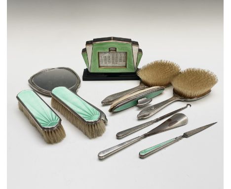 A silver and green enamel dressing table set - nine pieces, comprising of four brushes, a hand mirror, nail buffer, shoe horn