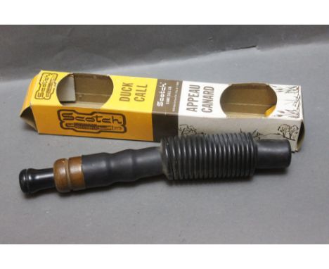 A Scotch duck call with original box.