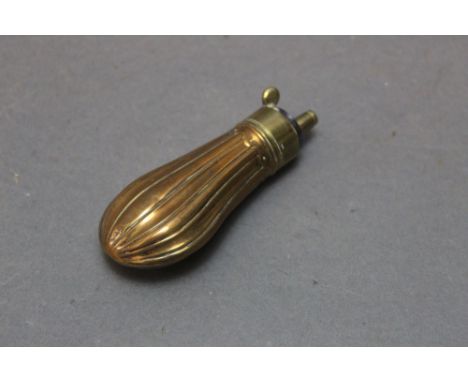 A brass and copper pistol powder flask, with fluted body, length 9 cm.