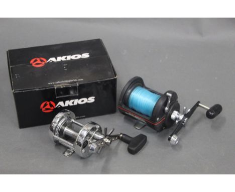 Akiaos S-Line 656 CTM multiplying reel with box, instructions, oil, tools etc. together with a Daiwa Sea Line SL250H multipli