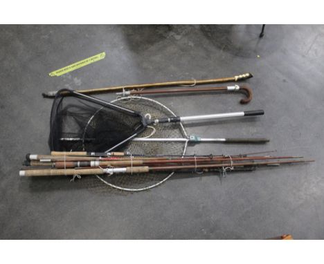 A salmon landing net, a trout landing net, wading stick, shooting stick and a bundle of fishing rods.