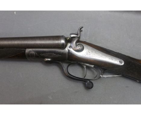 A Scott 12 bore side by side hammer shotgun, with 29 1/2" Damascus barrels, cylinder and cylinder choke, rotary under lever, 