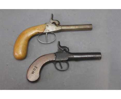 Two percussion pocket pistols, the first having a 2 3/4" cylindrical barrel with crude foliate carving to the hammer and acti