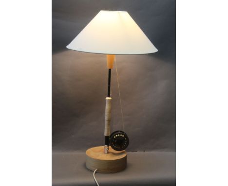 Lamp in the form of a Greys GRX fly rod, fitted with a LC Leda 100 trout fly reel, with turned wooden base and shade.  Height