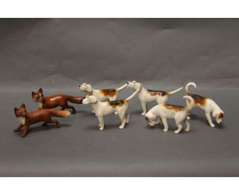 Five Beswick first version fox hounds, together with two foxes - one gloss one matt.