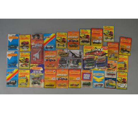 A quantity of  carded Matchbox Superfast and other small scale Matchbox diecast models,on various different styles of card pa