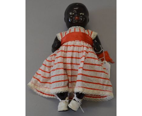 Vintage Black Pot doll, painted features, in vintage white dress with red stripes dots and sash plus white shoes. 