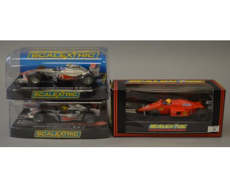 3 x Scalextric cars. C457 Ferrari F1. C3166 Vodafone McLaren Mercedes Jenson Button No4 2011. C2985 McLaren MP4-21 Lewis Hami