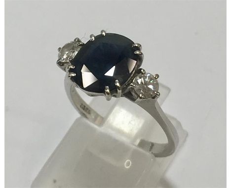 18ct White Gold Diamond & Sapphire Ring Large central Sapphire set with diamonds each side the large sapphire measures approx