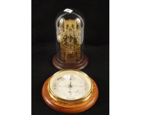 A contemporary Brass skeleton clock under dome and a modern circular aneroid barometer