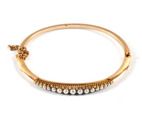 A Gold, Pearl and Diamond set hinged bangle