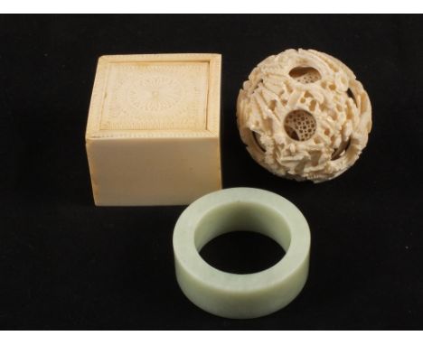 A 19th Century carved Indian Ivory box with sliding lid and a carved canton Ivory balls within ball, circa 1900, green Jade s