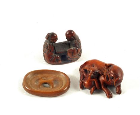 Two carved hardwood Netsukes and a button