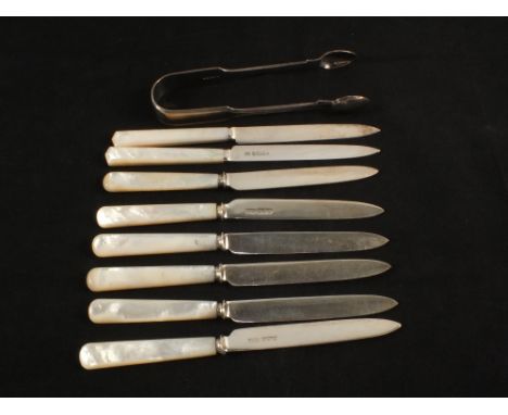 A set of eight Silver bladed Mother of Pearl tea knives and a pair of tongs