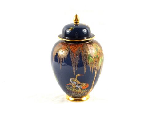 A Carlton ware blue ground vase and cover with gilt and polychrome tree and wading bird decoration, height 10"