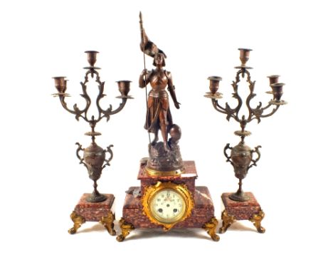 A striking clock garniture with spelter figure of Joan of Arc with floral painted porcelain dial on rouge marble base, accomp