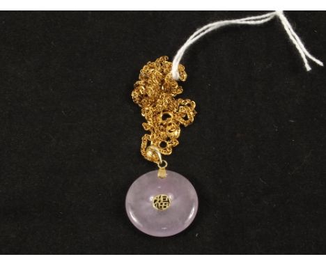 A Jade pendant hung from a 9ct Gold chain