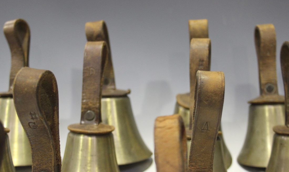 A Set Of Twenty Five 20th Century Brass Musical Hand Bells Ranging